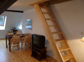 Esstisch und Treppe zum Schlafzimmer