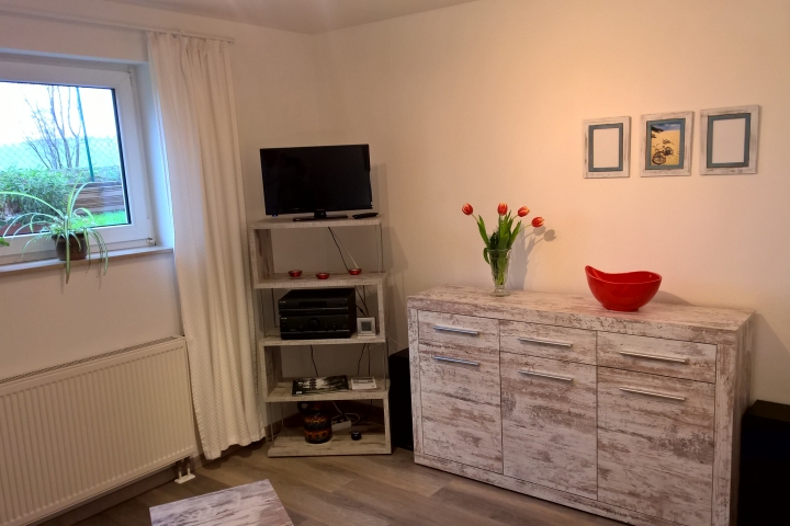 Wohnzimmer modern möbliert mit Fernseher und Stereoanlage