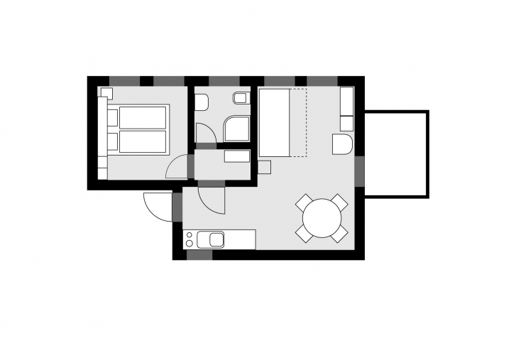 mittlere Wohnung (C), Grundriss von v.l.n.r.: Schlafzimmer, Bad, Garderobe, Wohnzimmer mit Küchenzeile und Essplatz sowie Ausgang zur Terrass