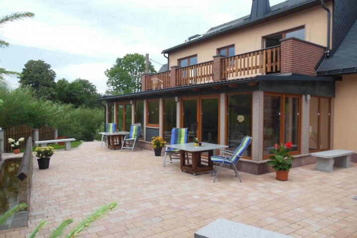 Rückseite des Hauses mit Blick auf die Wintergärten bzw. Gemeinschaftsraum und Terrasse mit Grillmöglichkeit
