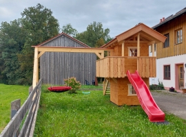 Spielhaus mit Schaukeln und Rutsche