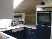Moderne Küche mit Backofen, Mikrowelle, Kühlschrank, Geschirrspüler, Vier-Platten-Heran-Kochfeld