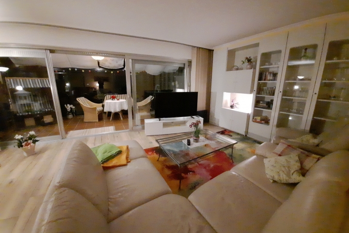 Wohnzimmer, mit Fensterfront zum Wintergarten.