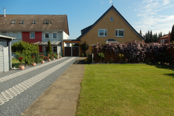 Einfahrt zum Grundstück mit Parkplatz auf dem Rasen